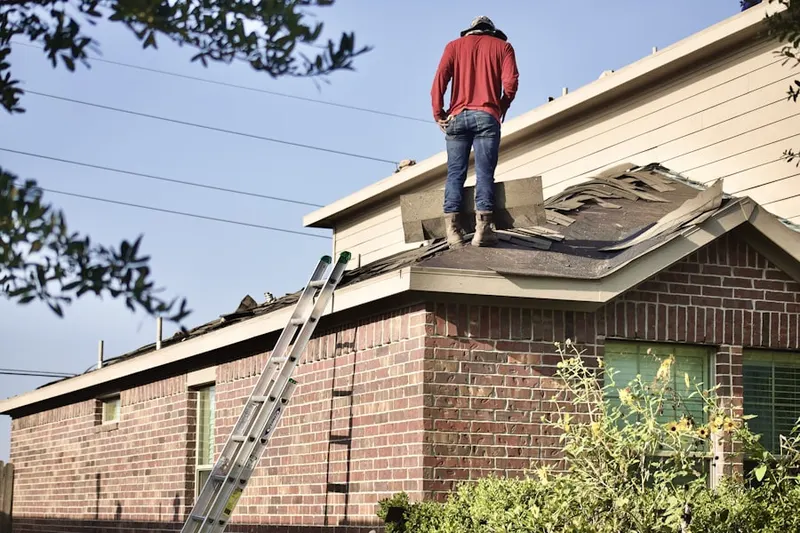Professional roofer working on a residential roof in Park Layne